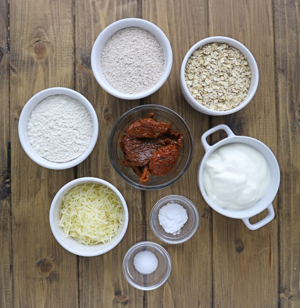 sun-dried tomato and cheese soda bread ingredients on a brown wooden board