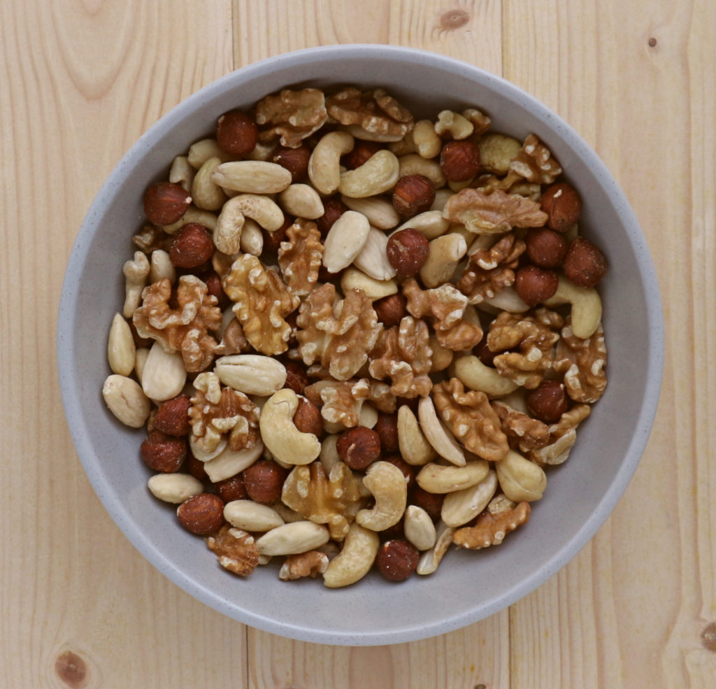 grey bowl filled with mixed nuts for granola
