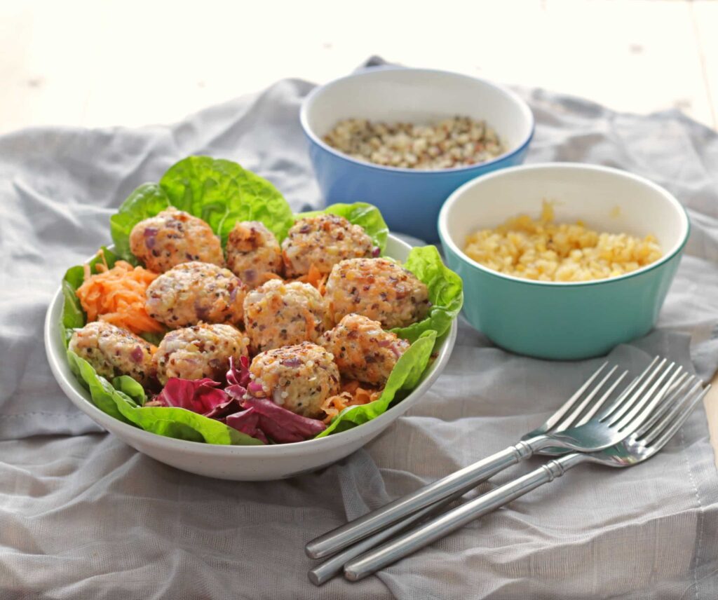 Salmon Bites in a bowl with lentils and quinoa in separate bowls.