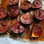 honey roasted figs cut in half on a baking tray.