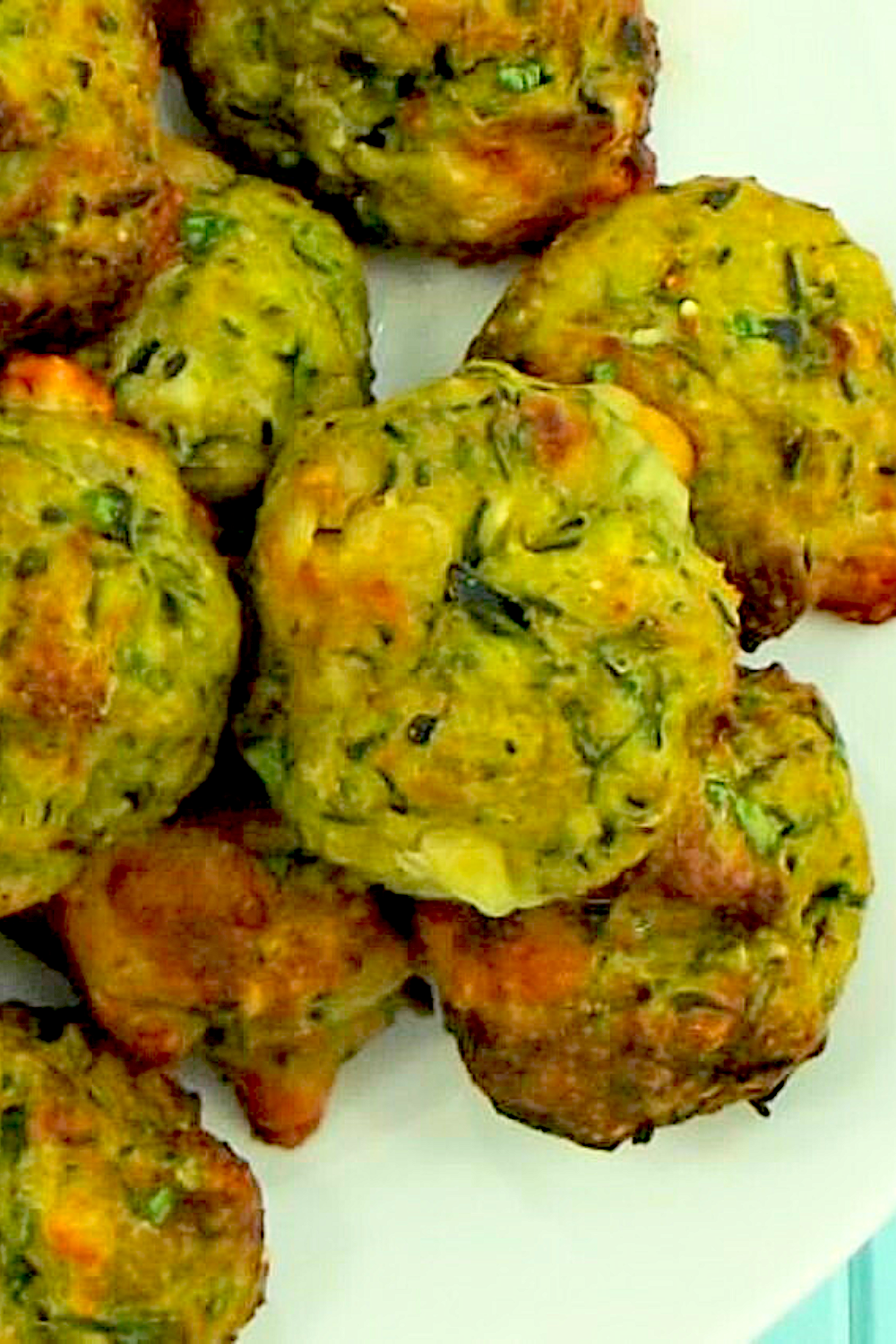 Cheesy Zucchini Vegetarian Bites stacked up on plate
