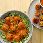 vegan meatballs in a grey bowl on a blue teatowel
