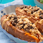 Vegan black bean stuffed sweet potatoes in a blue dish