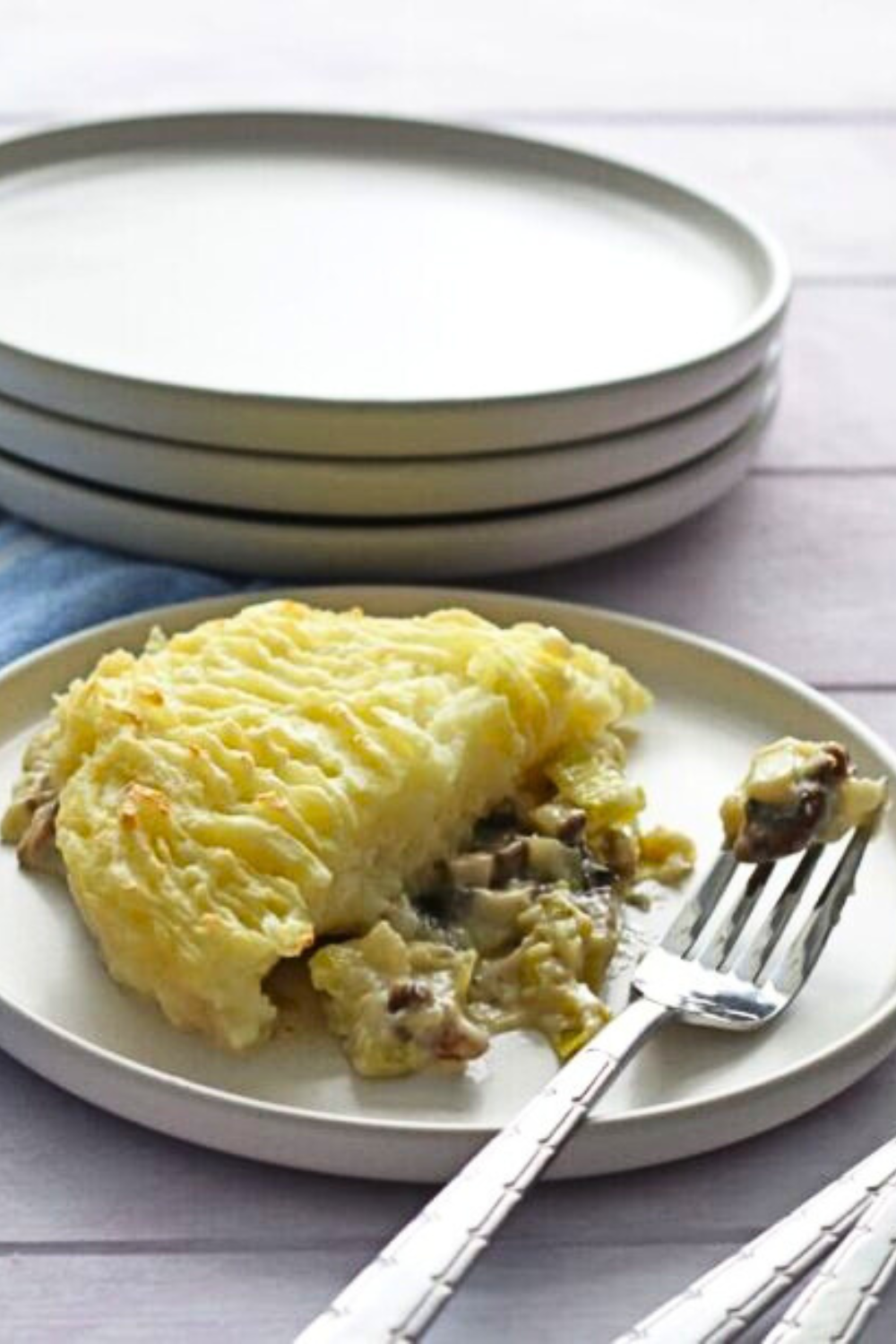 Cheesy Mushroom and Leek Potato Pie on white plate with fork