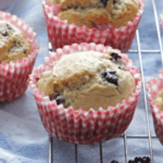 blackberry muffins on cooling rack with red checkered liners