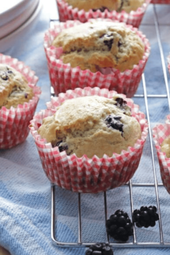 blackberry muffins on cooling rack with red checkered liners