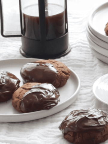 Lebkuchen on plates with a cup of coffee and cafetiere.