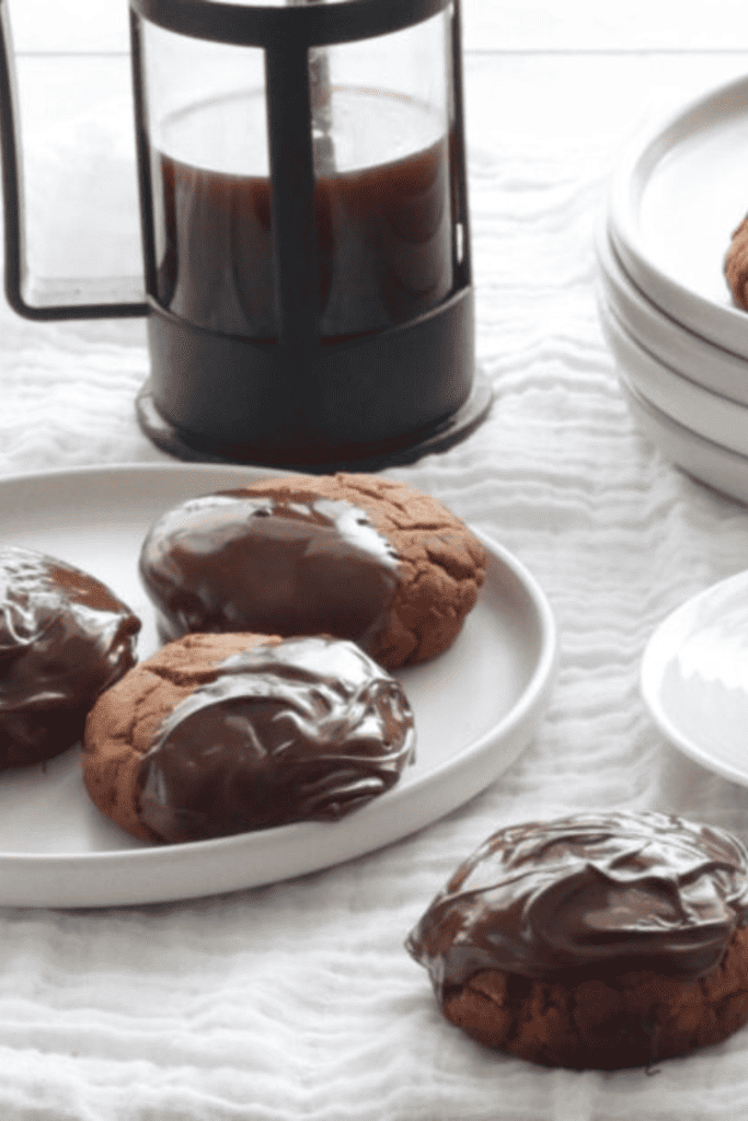 Lebkuchen on plates with a cup of coffee and cafetiere.