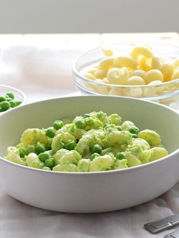 Easy Pea Pesto with Spirali Pasta in white bowl with pasta in background