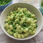 Pea pesto pasta in a white bowl.