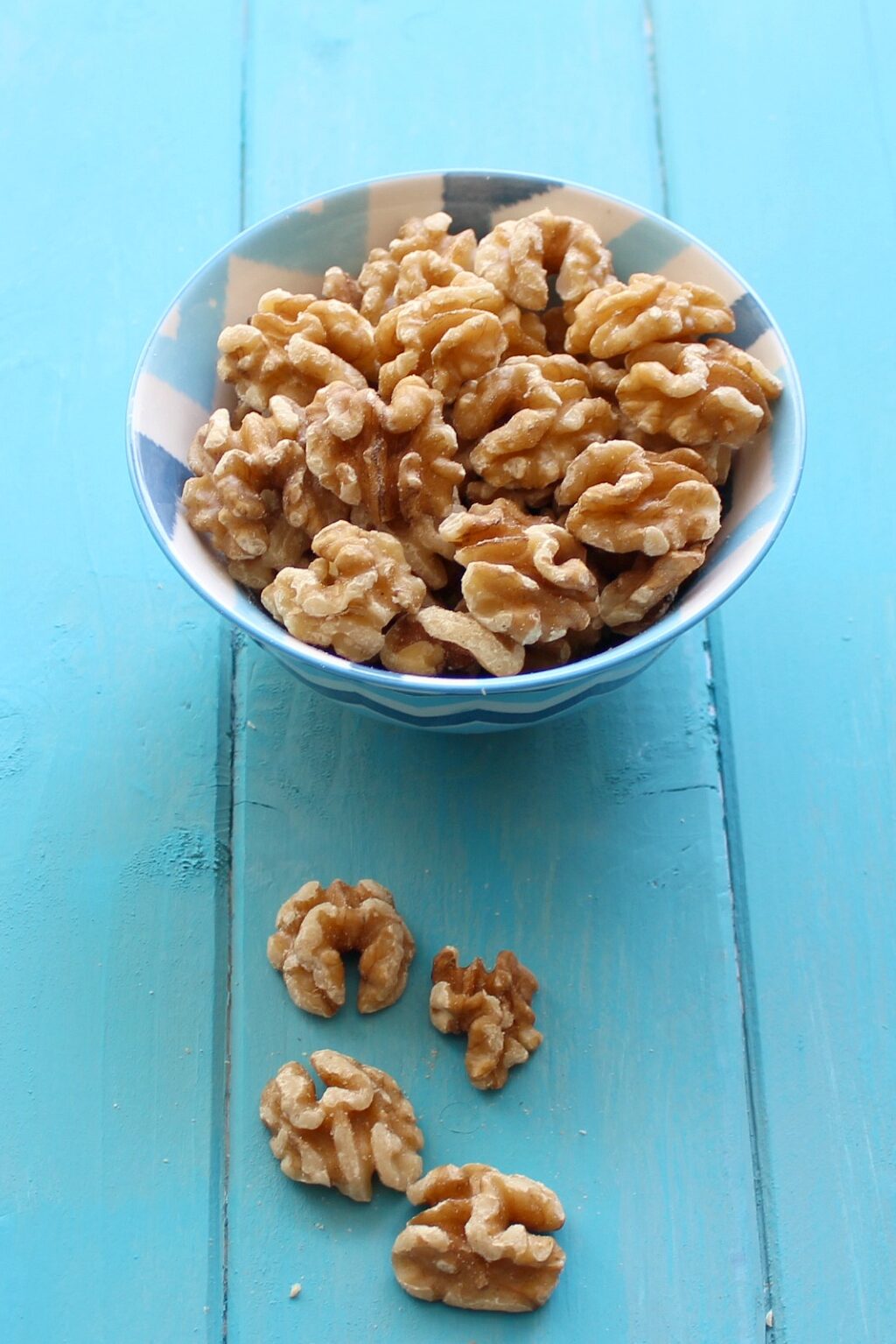 walnuts on a blue board.