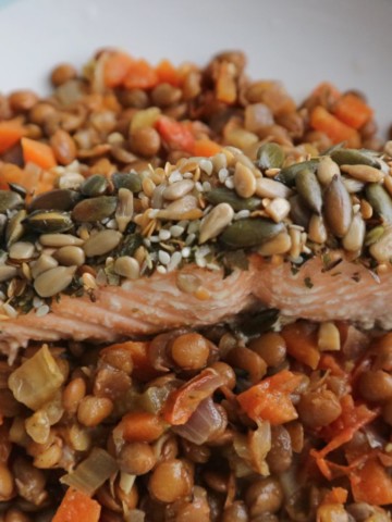 Roasted seeded salmon on a white plate.
