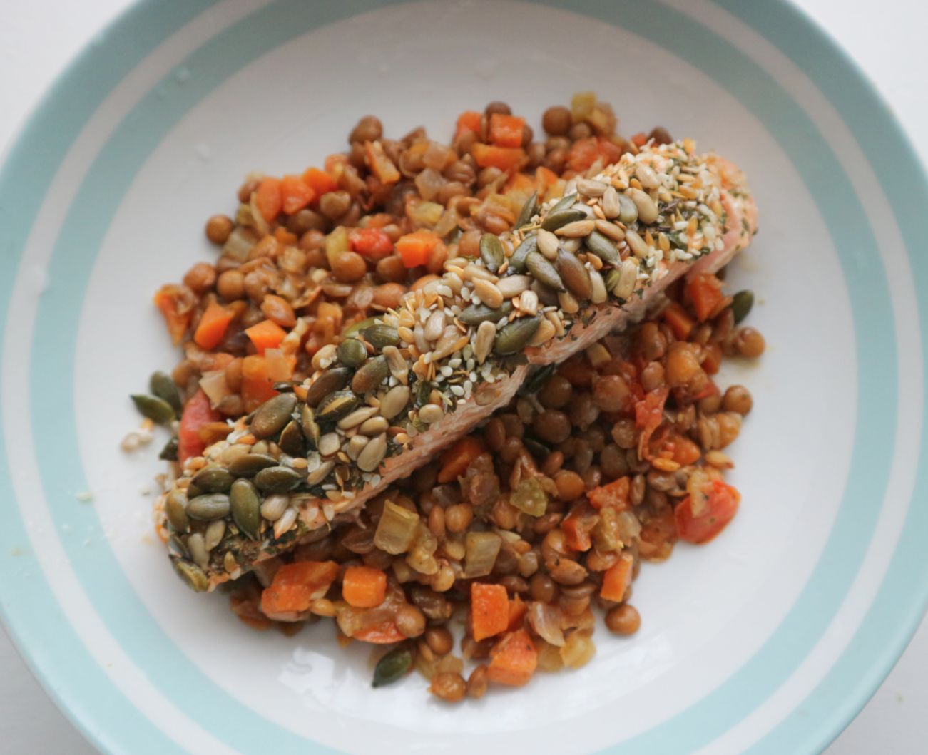 Roasted seeded salmon on a white plate.