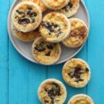 Mini Quiches on a grey plate.