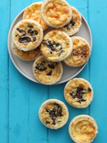 Mini Quiches on a grey plate.