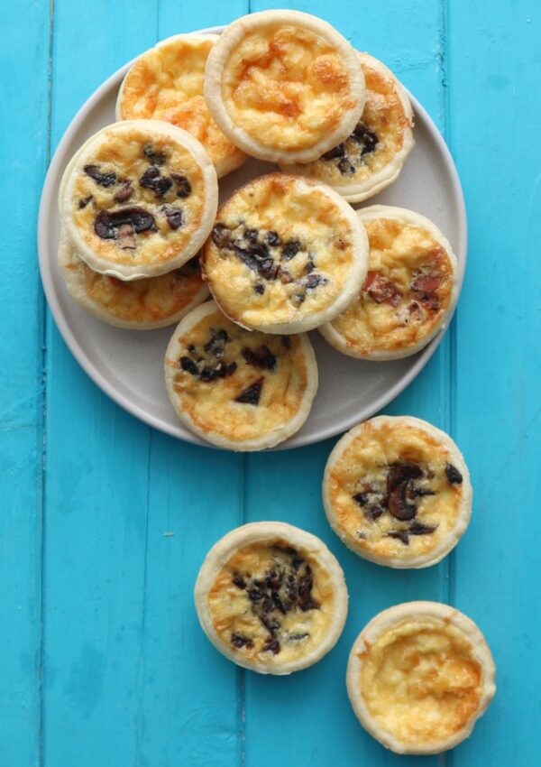 Mini Quiches on a grey plate.
