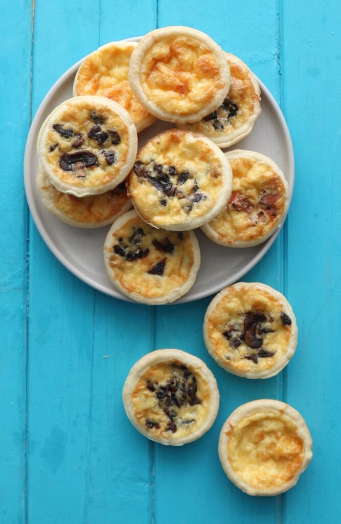 Mini Quiches on a grey plate.