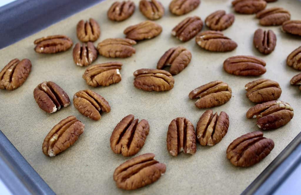 pecan halves on baking sheet