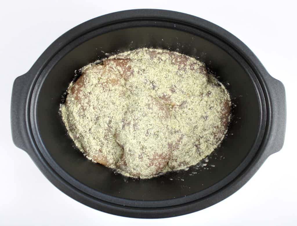 chicken with ranch seasoning on top in slow cooker