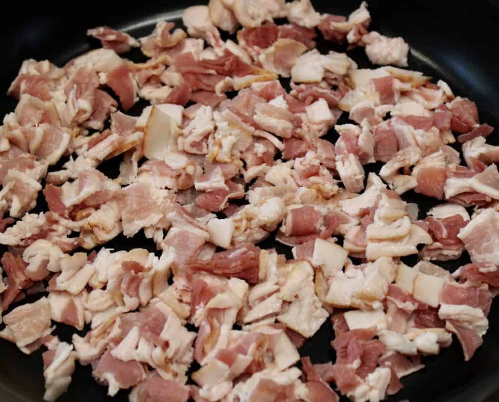 raw chopped bacon in skillet