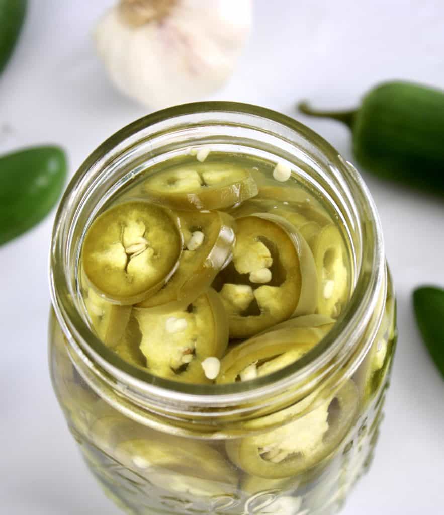 Pickled Jalapeños in open jar