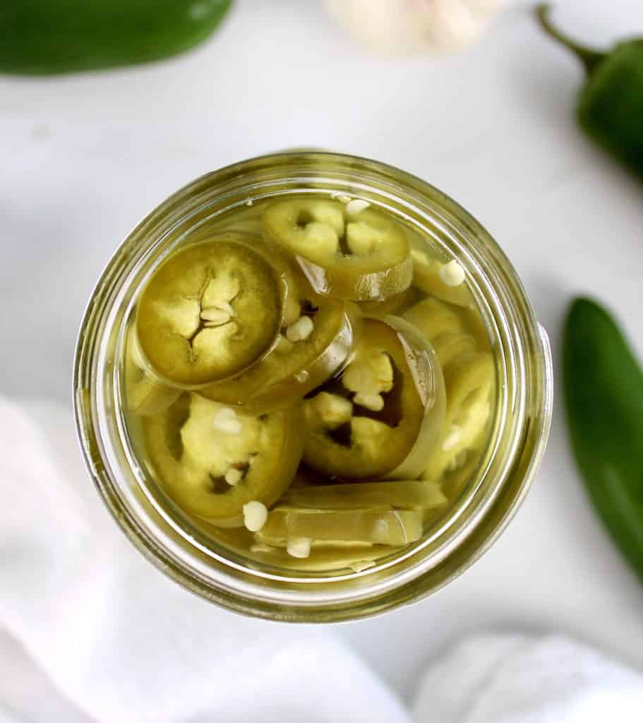 overhead view of jalapeno pepper rings in jar