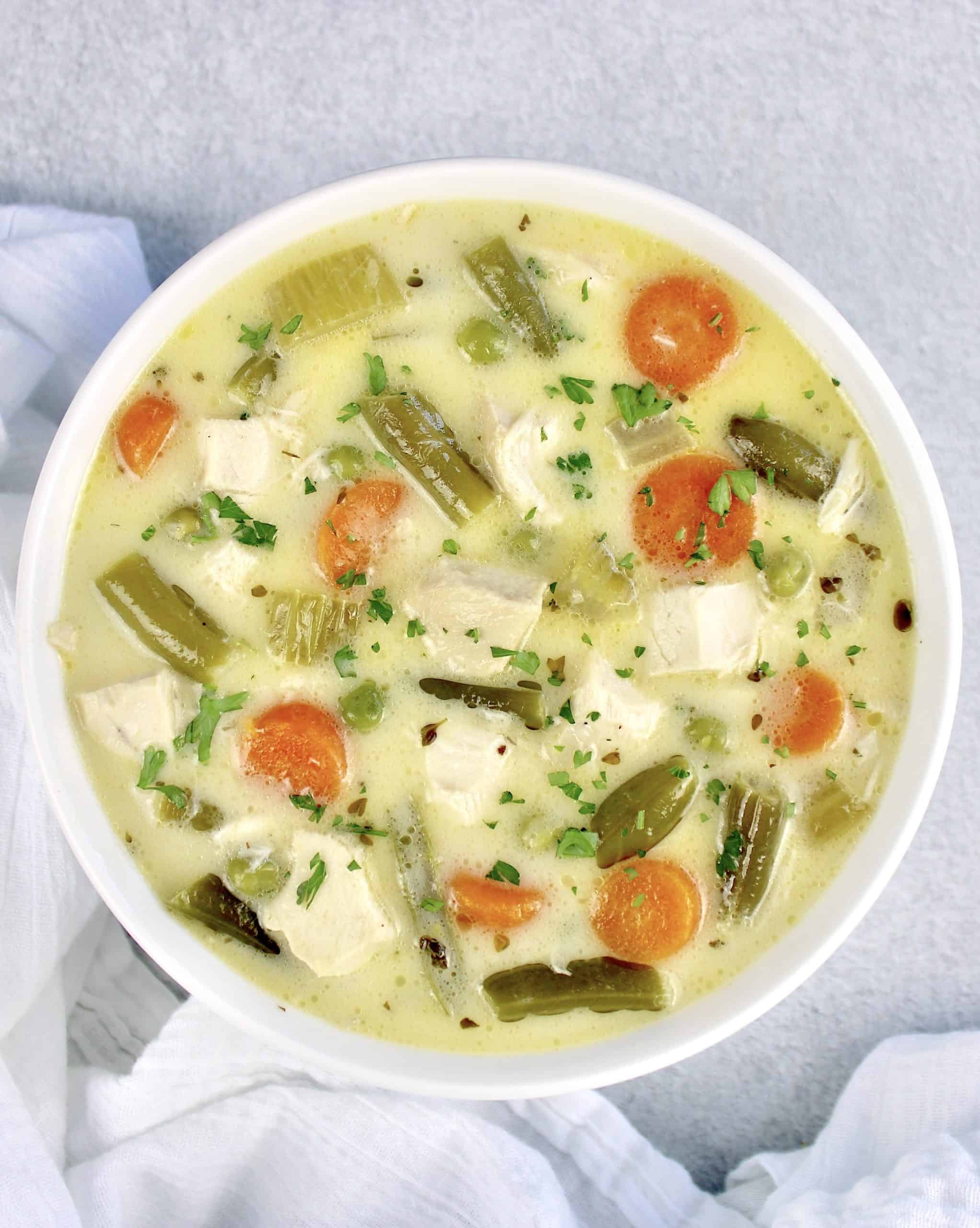 overhead view of bowl of Chicken Pot Pie Soup in white bowl