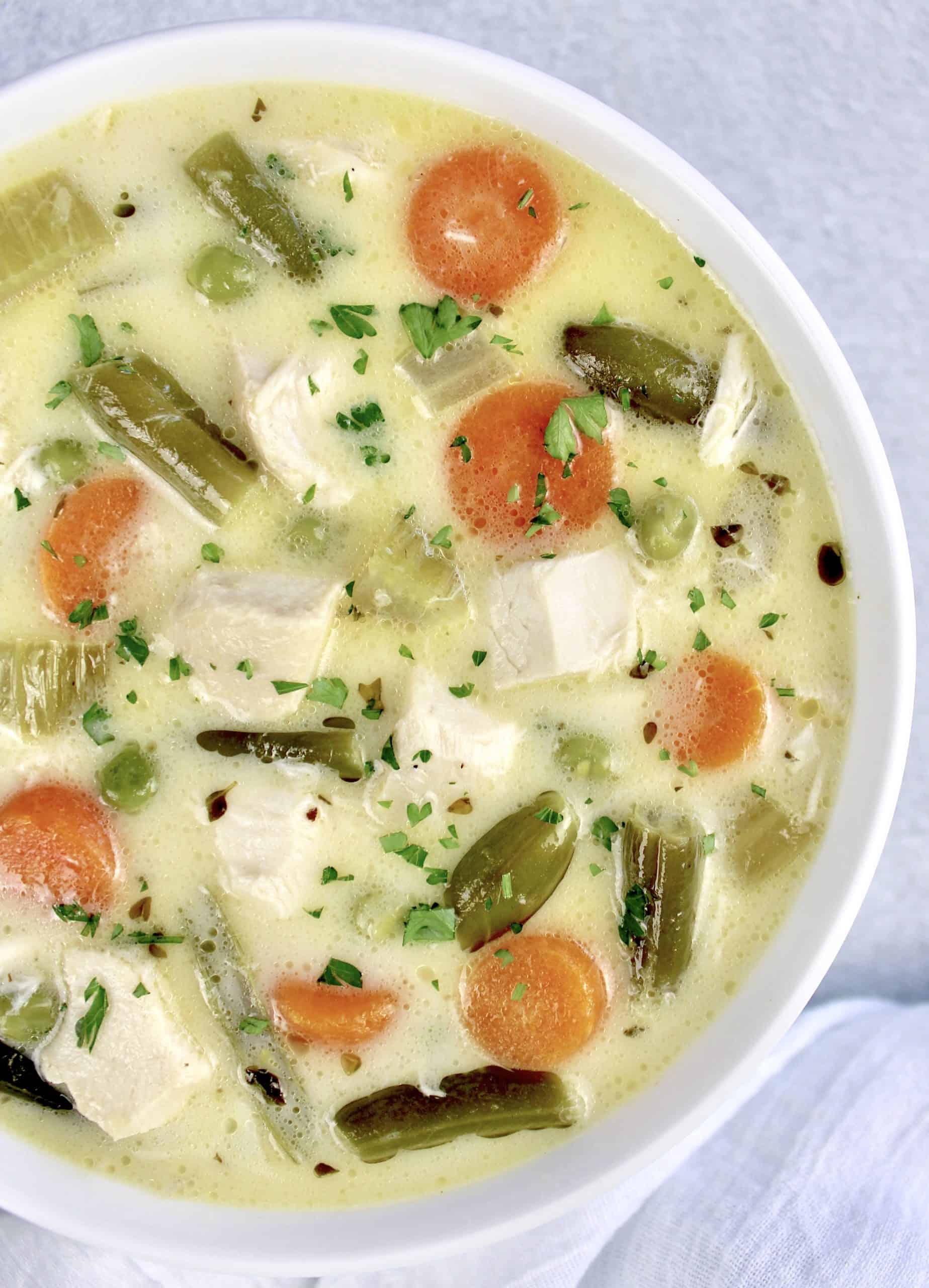 overhead view of Chicken Pot Pie Soup in white bowl