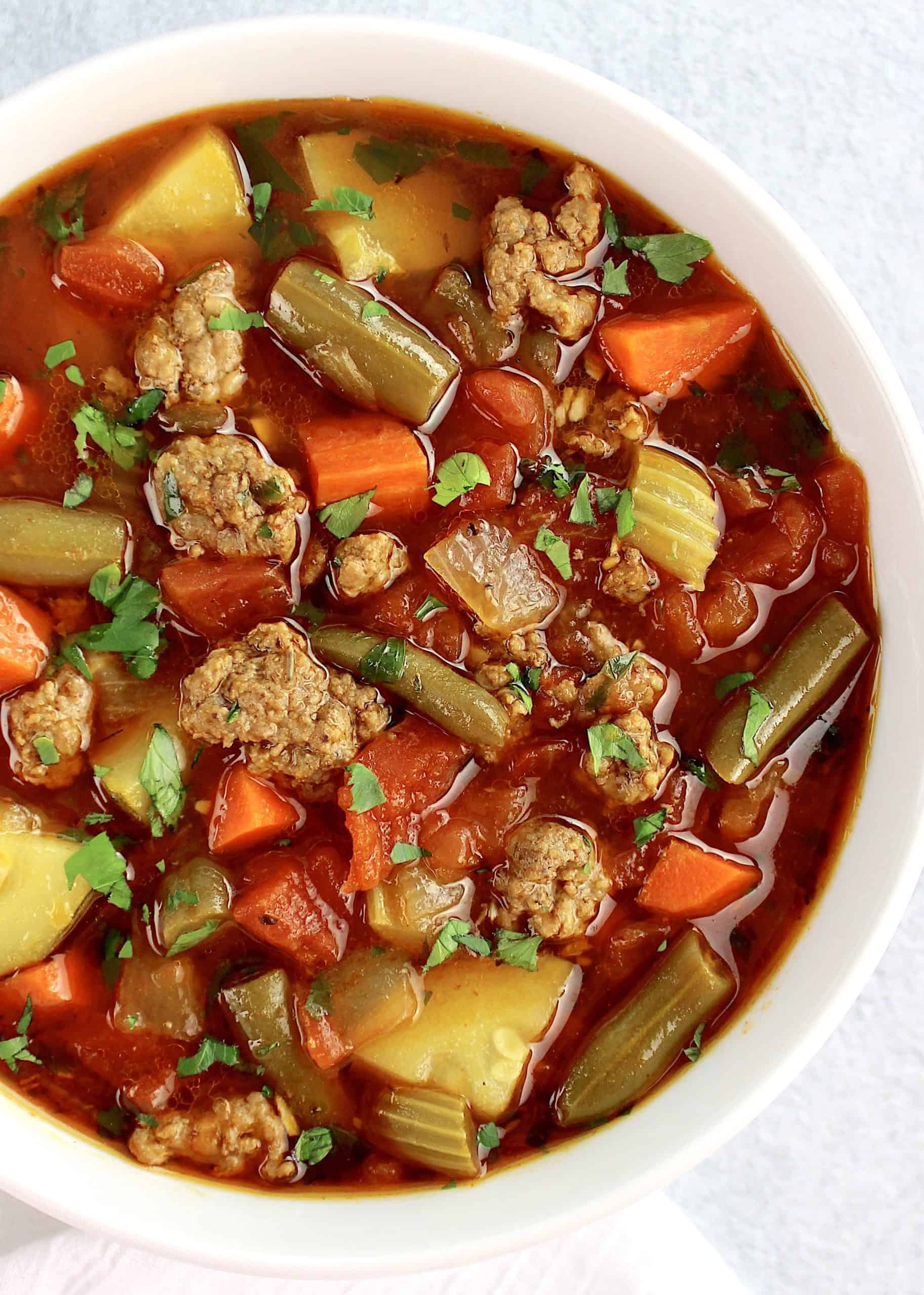 overhead closeup view of Vegetable Beef Soup in white bowl