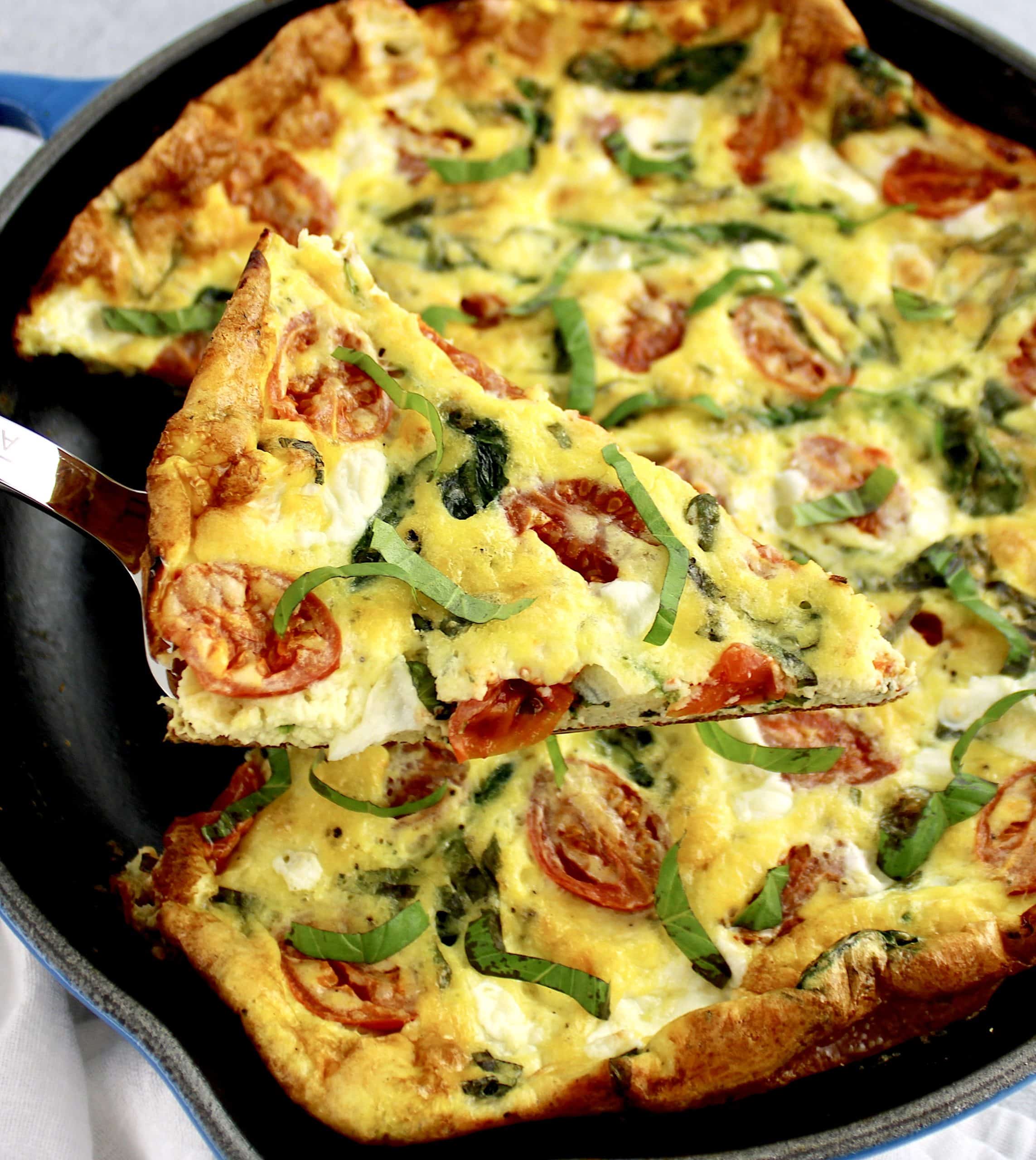 Caprese Frittata with slice being held up