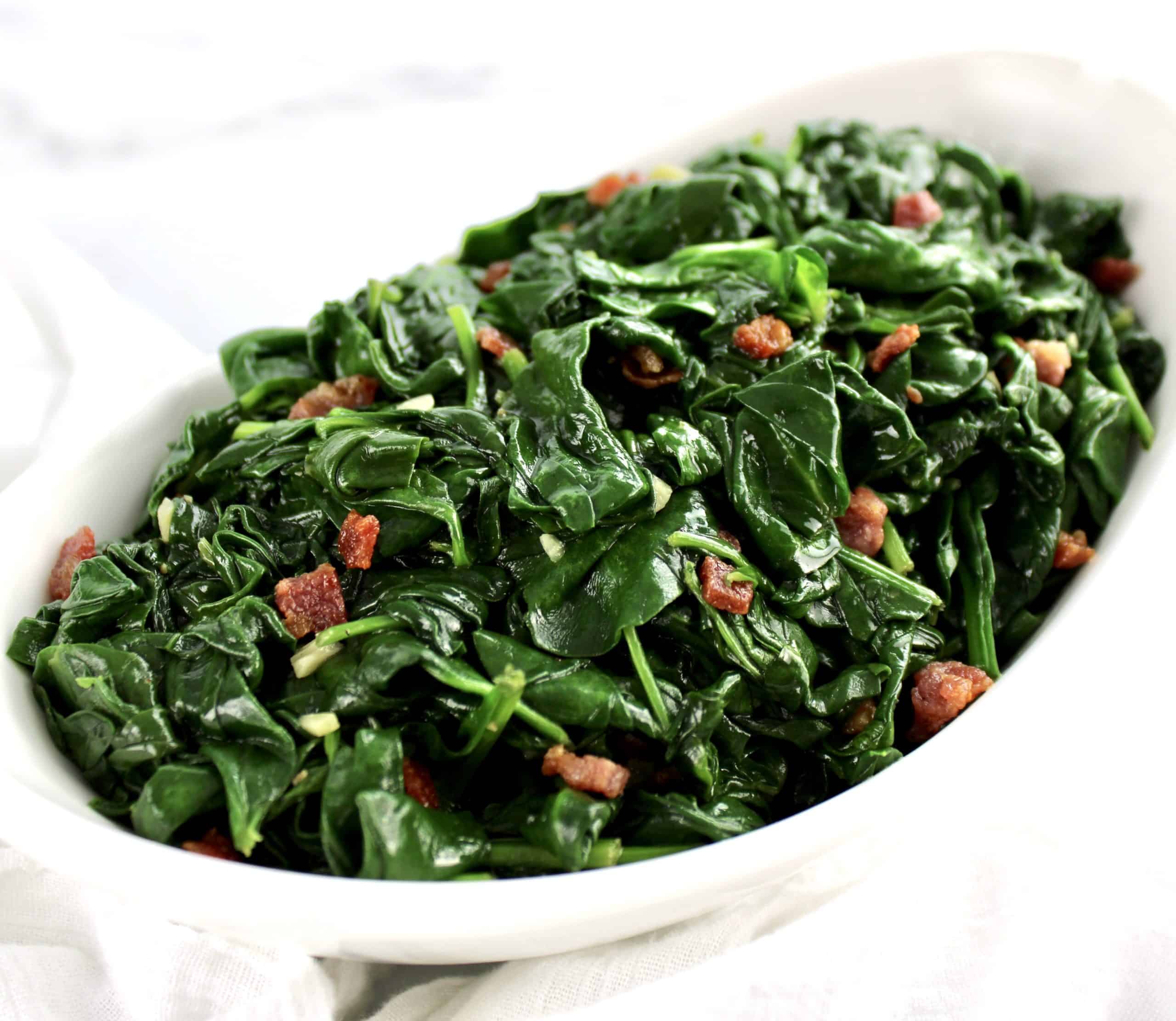 Sautéed Spinach with Pancetta in white bowl