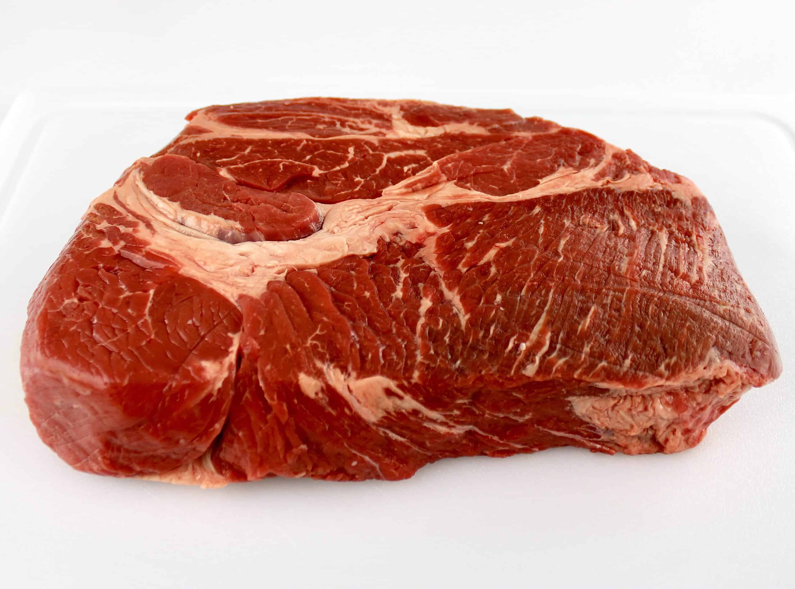 chuck roast on white cutting board