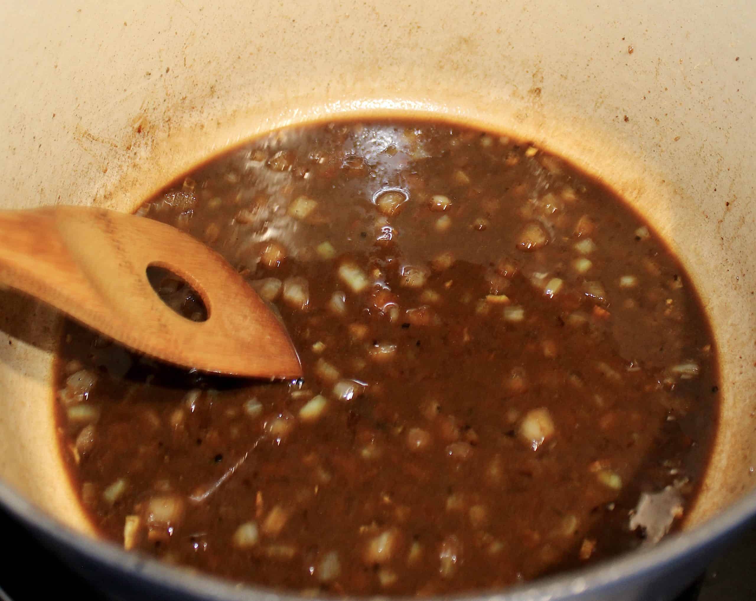 beef broth with onions in pan
