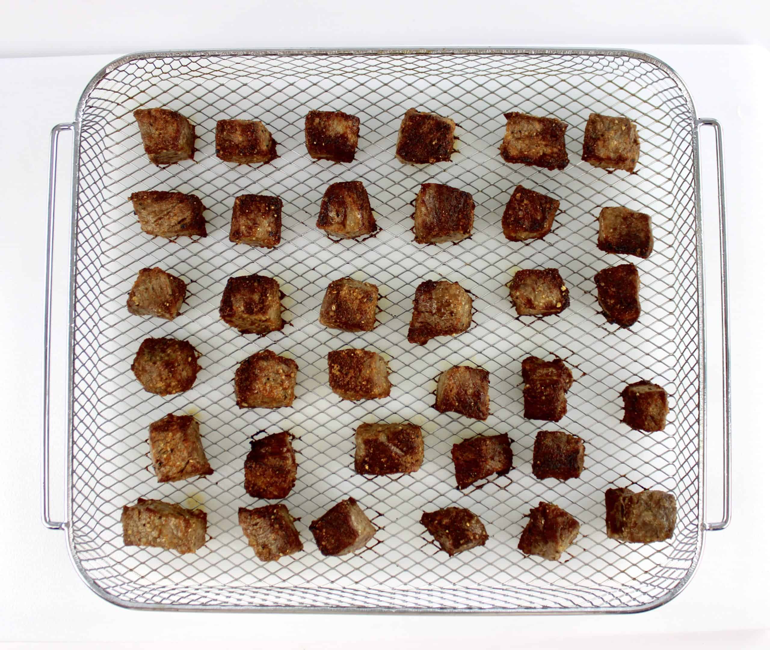 steak bites cooked in air fryer basket rack