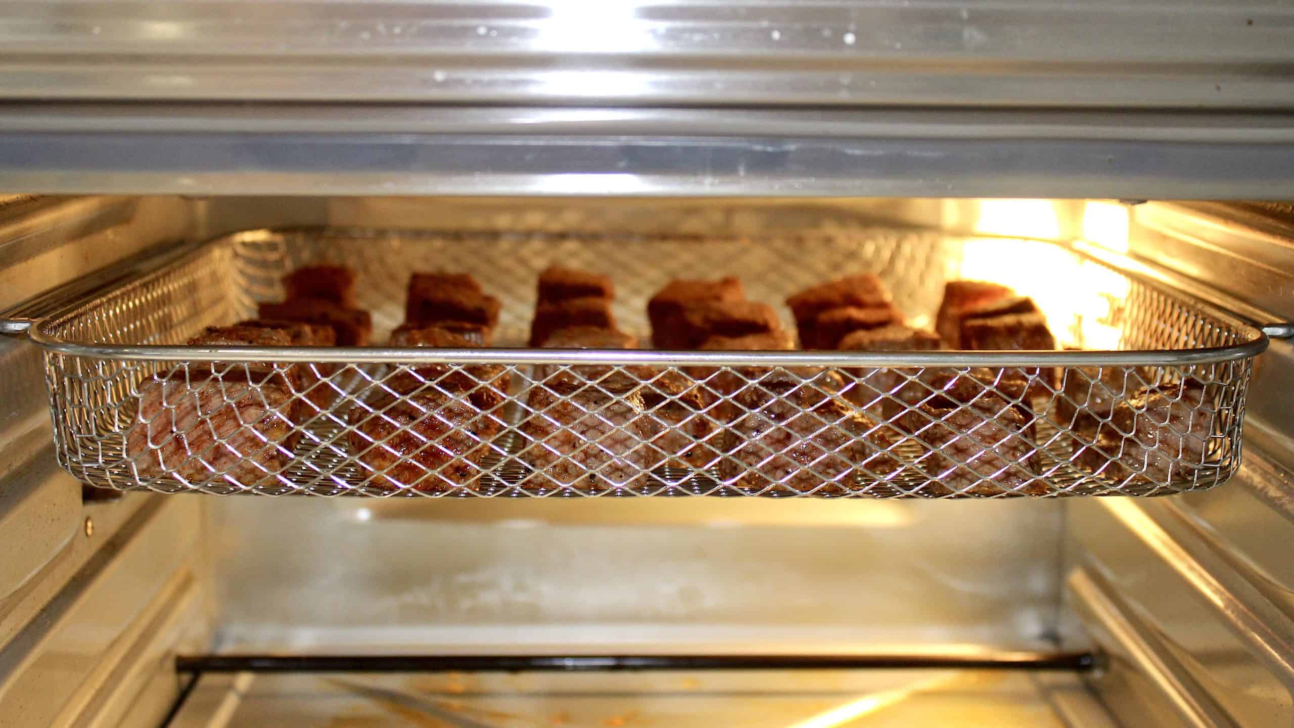 steak bites on top rack in air fryer oven