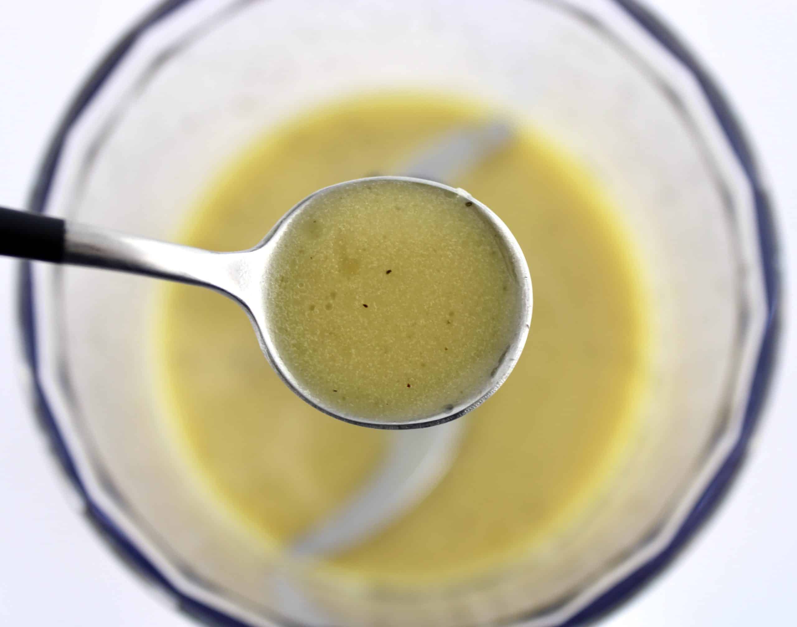 Mediterranean Cucumber Salad dressing in spoon over mini chopper