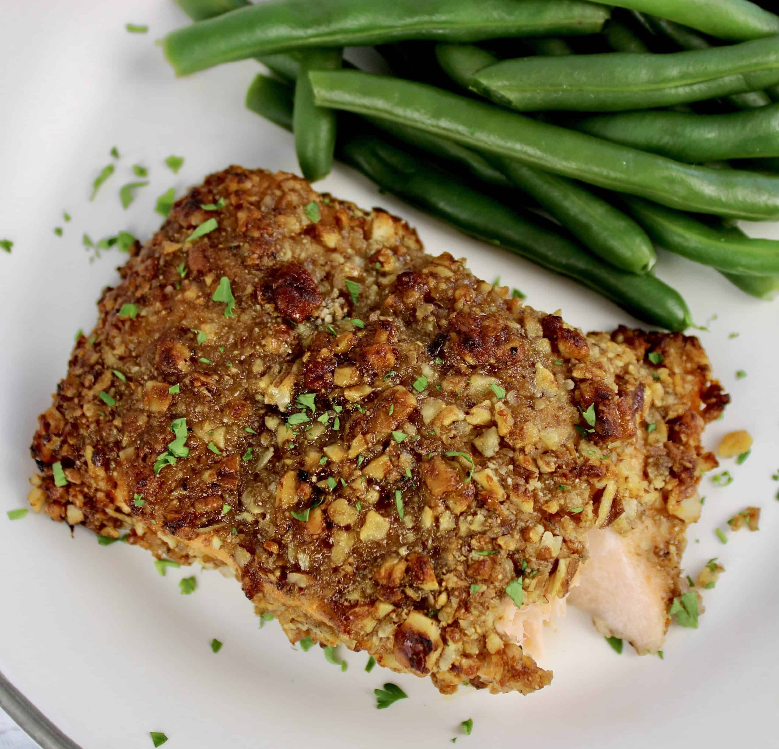 Pecan Crusted Salmon on white plate with bite missing