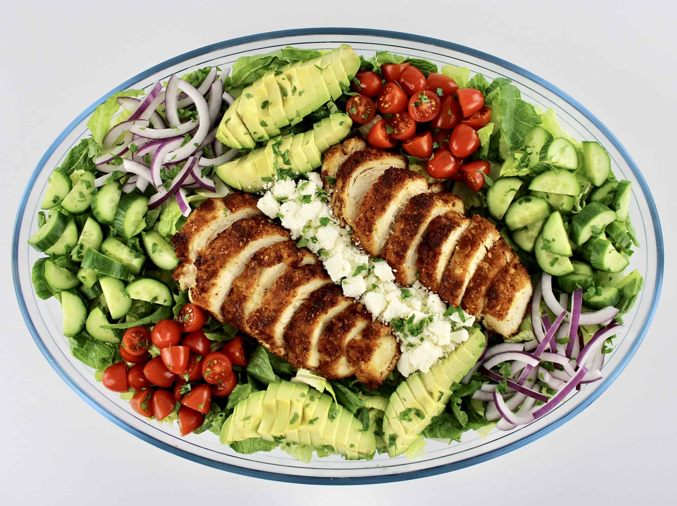 Crispy Chicken Salad  with chopped parsley on top in glass oval bowl