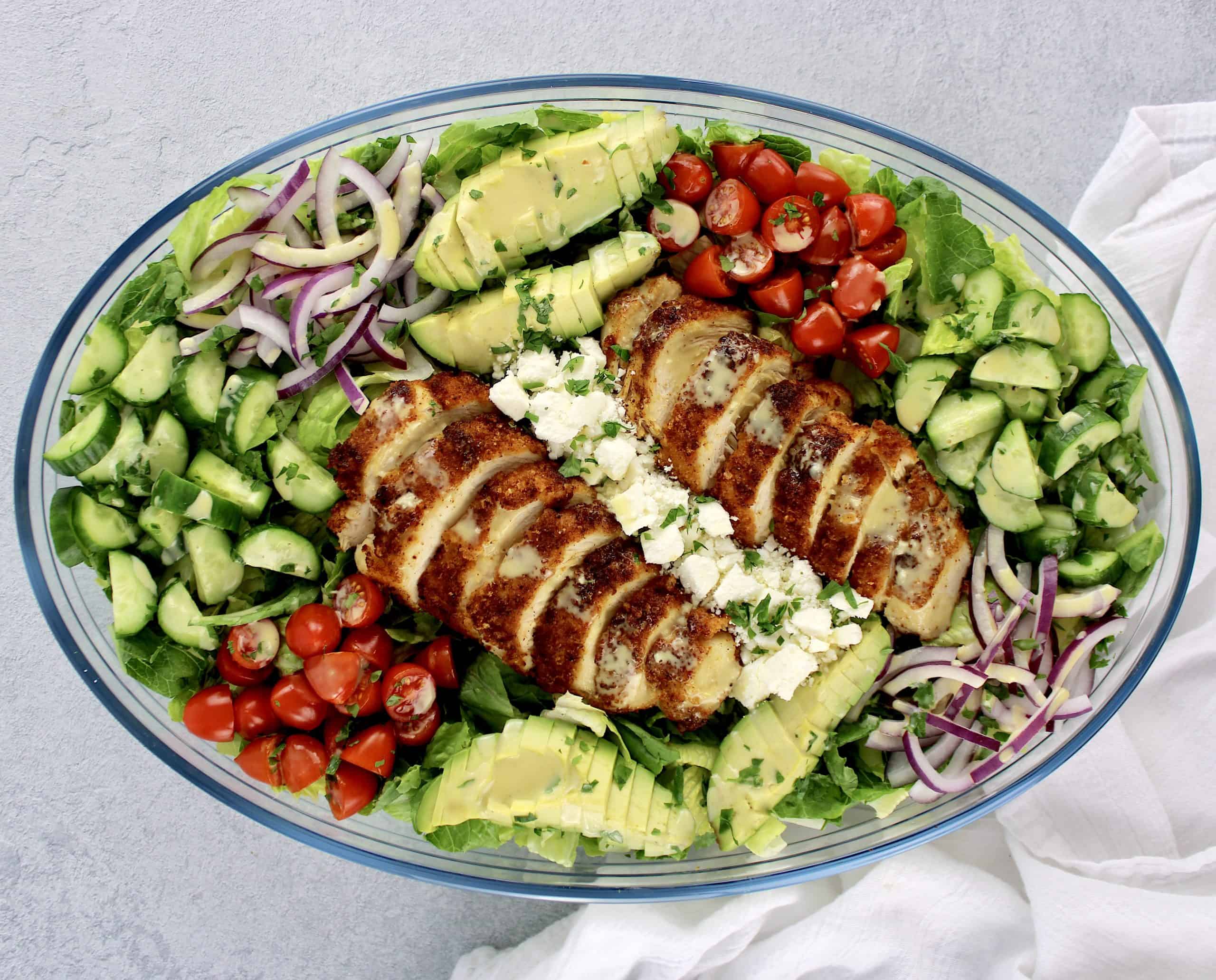 Crispy Chicken Salad with chopped veggies in glass bowl