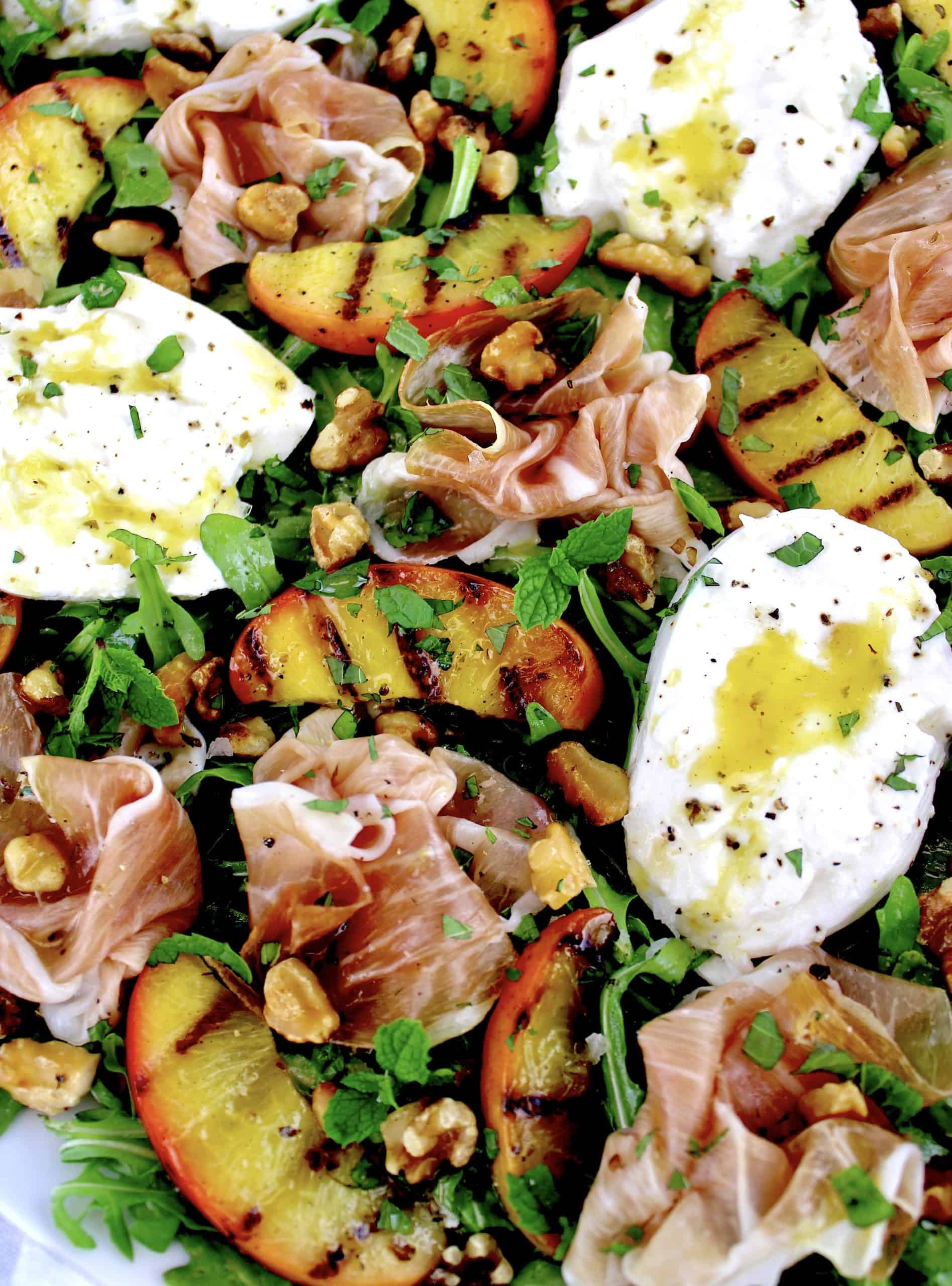 Grilled Peach Burrata Salad with Prosciutto and dressing drizzled on top
