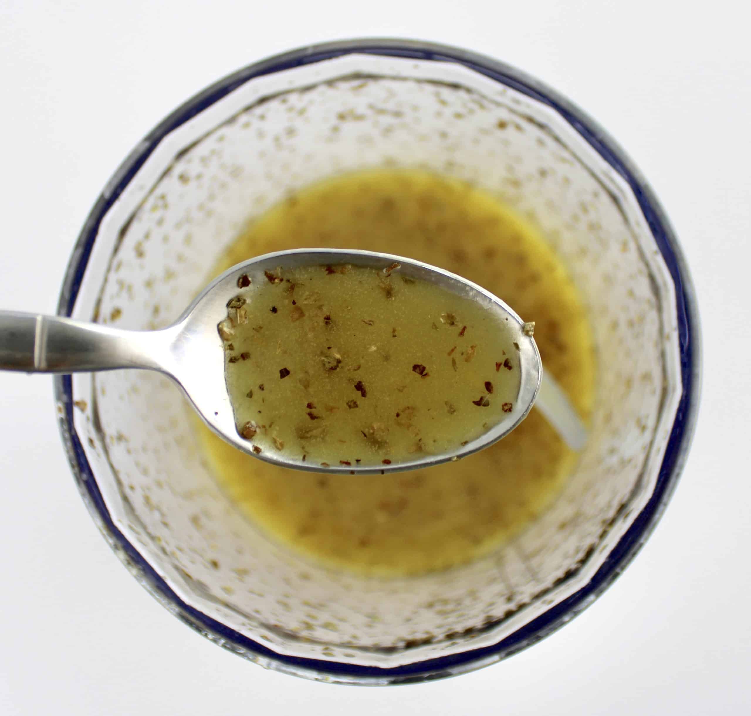 burrata salad dressing in mini chopper and spoon holding up some
