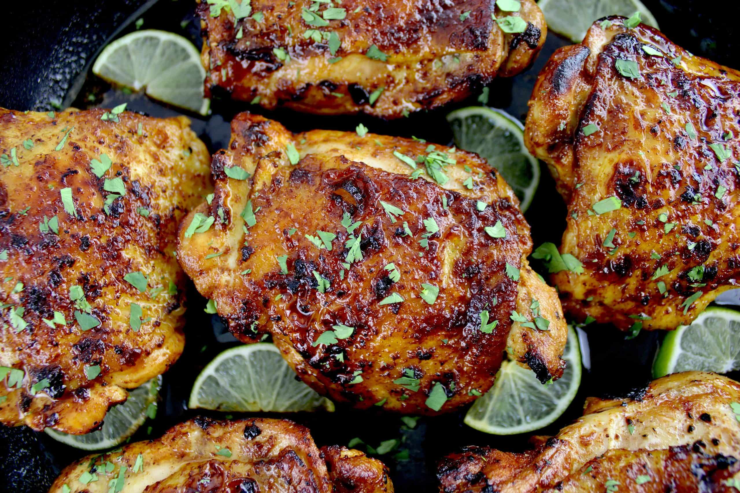 closeup of Paprika Chicken Thighs in skillet with chopped cilantro