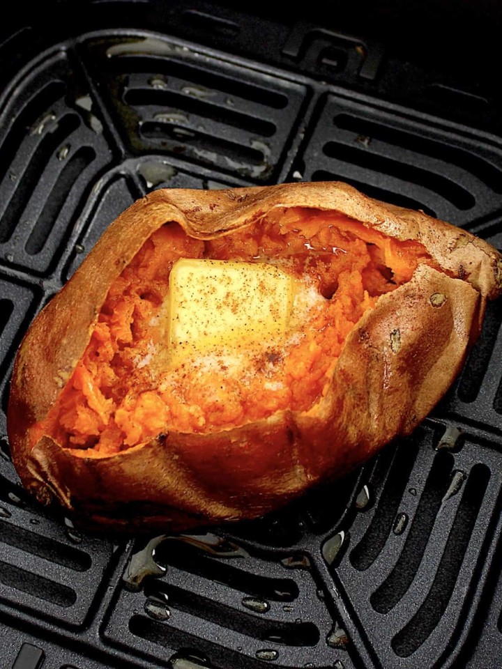 closeup of sweet potato in air fryer with butter
