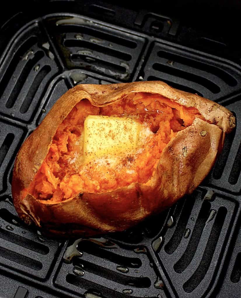 closeup of sweet potato in air fryer with butter