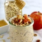 Apple Cinnamon Overnight Oats with honey being drizzled on top