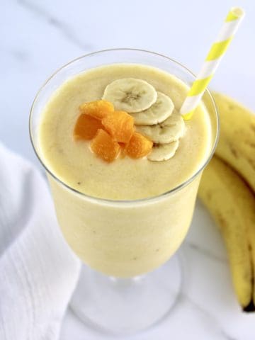 Banana Peach Smoothie with banana slices and peach chunks on top