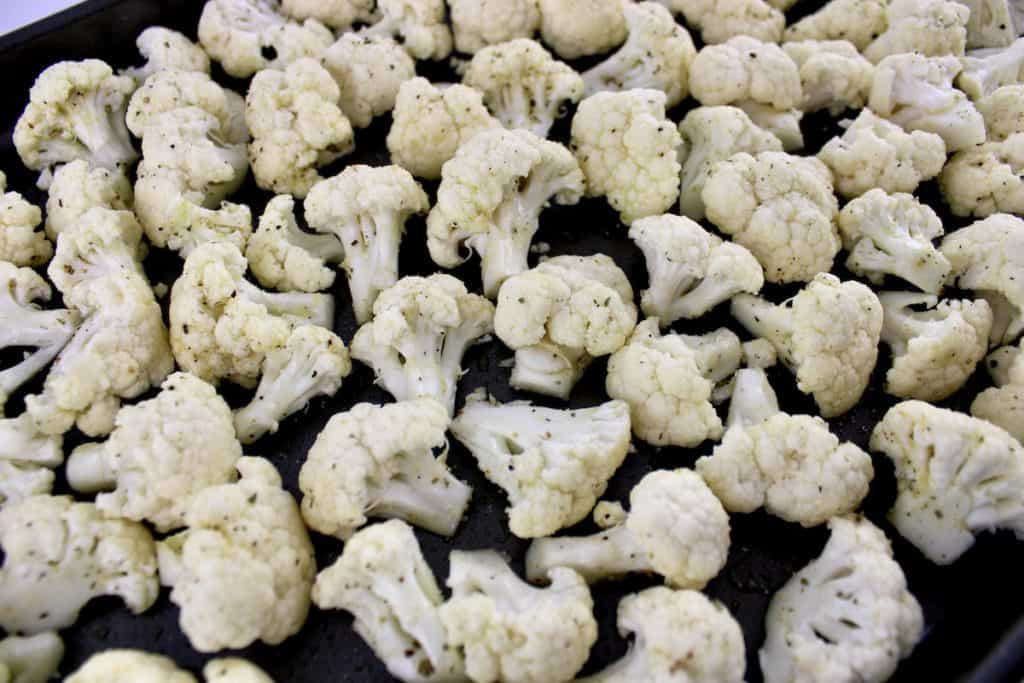 closeup of cauliflower florets with olive oil and garlic salt on top