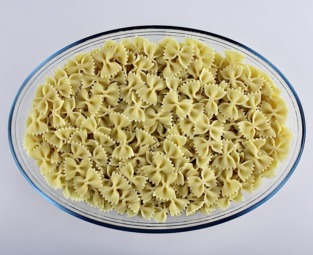cooked farfalle pasta in oval glass bowl