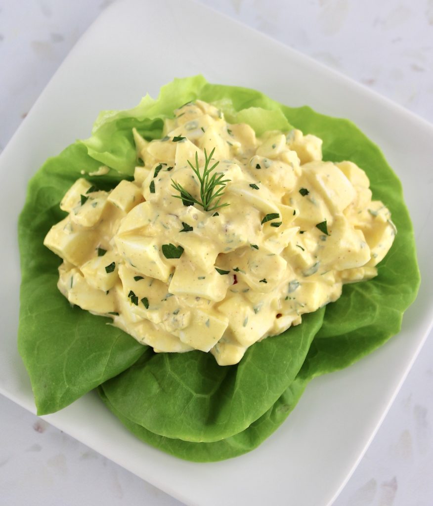 Egg Salad in lettuce cup on white square plate
