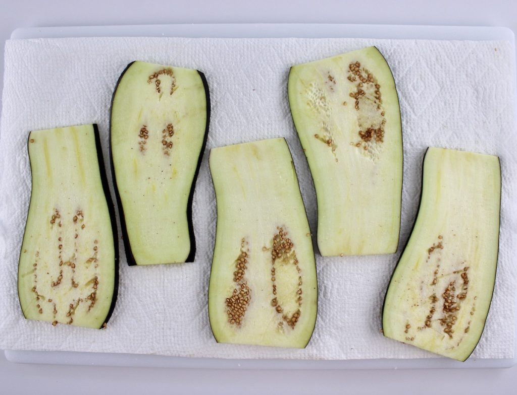 slices of eggplant on paper towels with salt on top